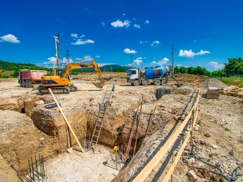 Heavy equipment and foundation work on a development site, illustrating construction engineering strategies that support multi-phase projects.