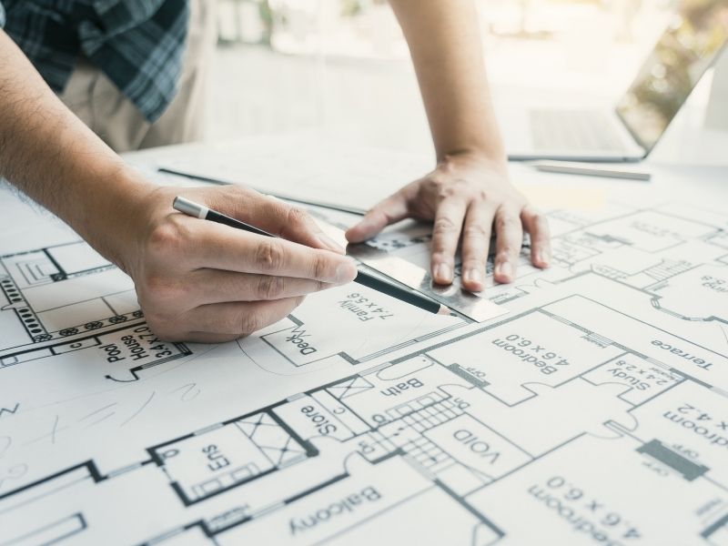 Engineer reviewing a site design plan to allow for future expansion and long-term property development.