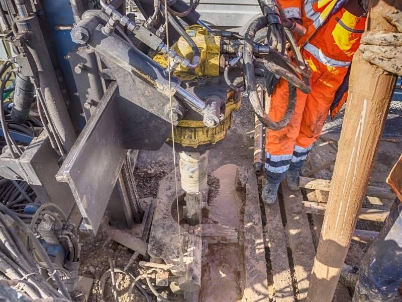 Geotechnical drilling crew collecting soil core samples at a commercial development site in Charlotte, NC, to evaluate soil conditions for foundation, grading, and drainage design.